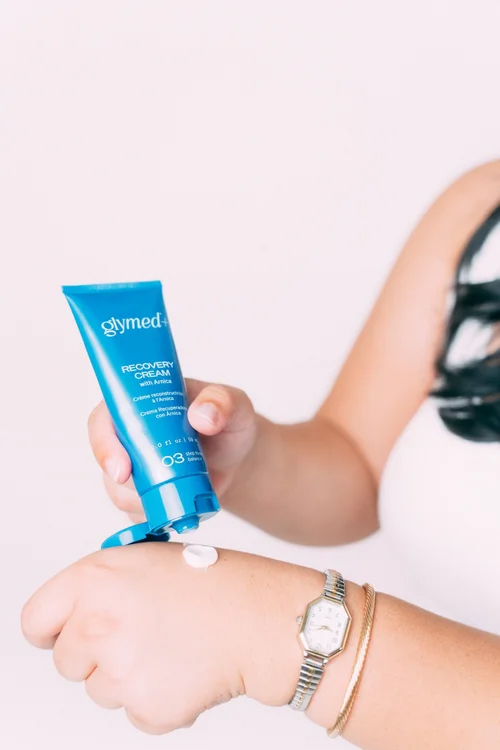 GlyMed+ Recovery Cream with Arnica being applied to the hand